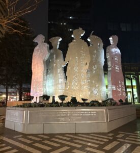 Lexington_19th Amendment Several metal sculptures of suffragettes overtop of a plaque dedicating the monument to the passing of the U.S. Constitution's 19th Amendment.